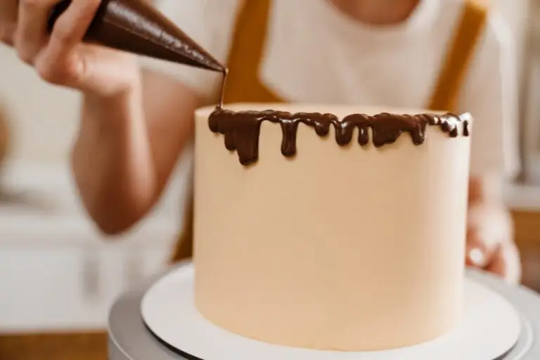 Caucasian pastry chef woman making cake with chocolate cream